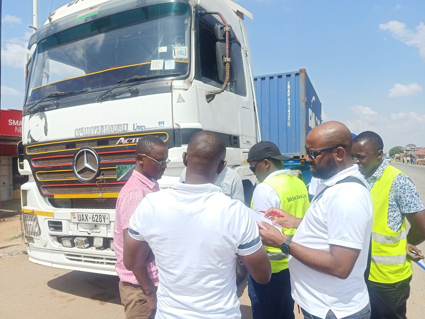  The RSS multidisciplinary Survey team interview a truck driver parked along the highway at Naluwerere, Uganda